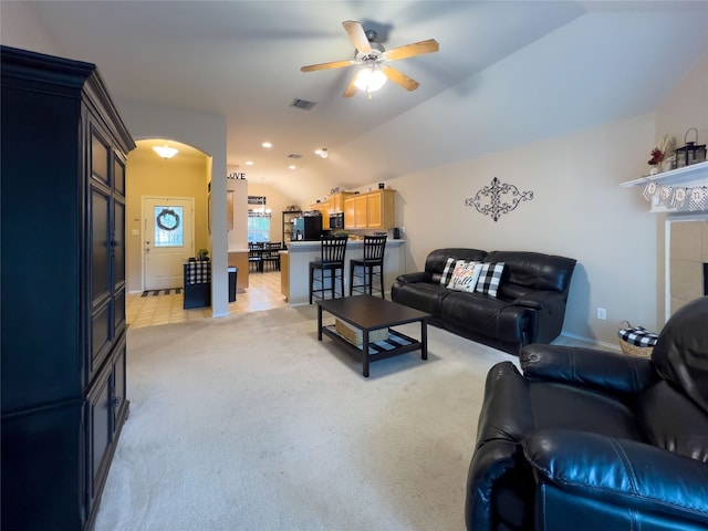 living room with light colored carpet, vaulted ceiling, and ceiling fan