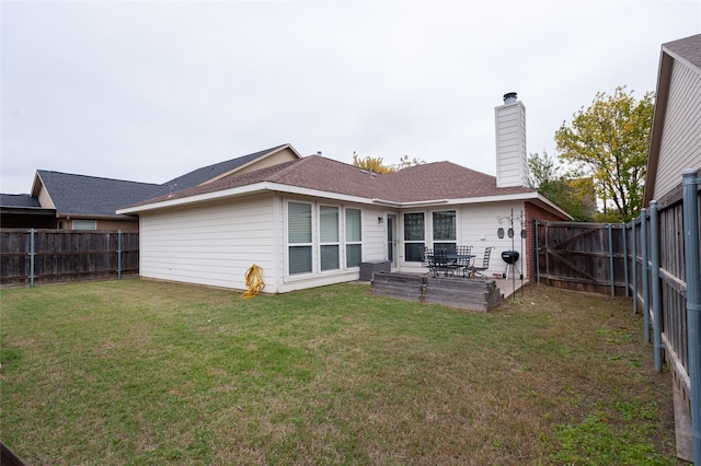 rear view of property with a lawn and a patio area