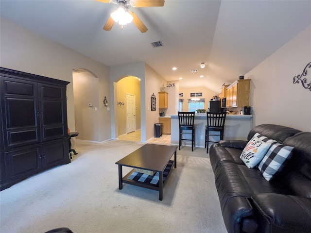 living room with light colored carpet, ceiling fan, and lofted ceiling