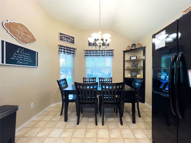 dining area featuring a notable chandelier and lofted ceiling