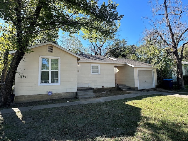 ranch-style home with a garage and a front yard