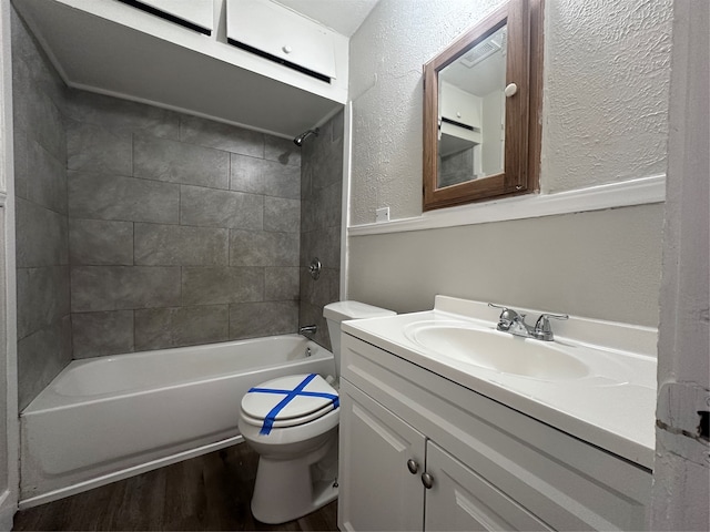 full bathroom featuring tiled shower / bath combo, toilet, wood-type flooring, and vanity