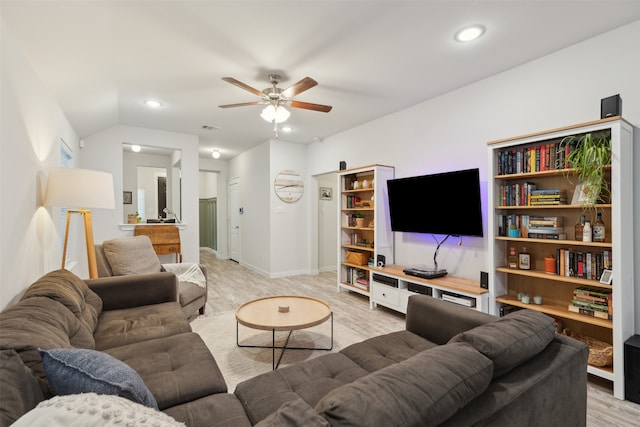 living room featuring light wood-type flooring, ceiling fan, and lofted ceiling