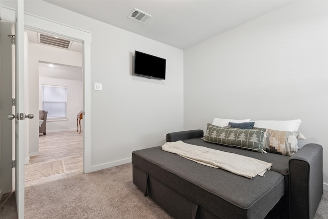 bedroom featuring light colored carpet