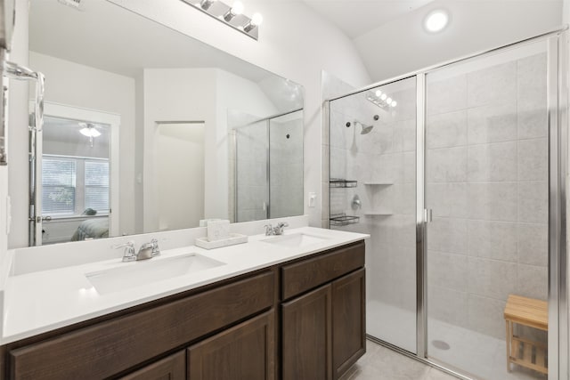 bathroom with tile patterned flooring, vanity, vaulted ceiling, and walk in shower