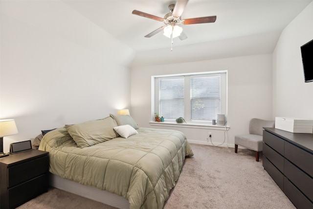 bedroom with ceiling fan, light carpet, and vaulted ceiling