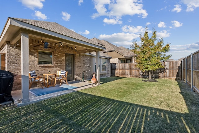 back of property featuring a yard and a patio