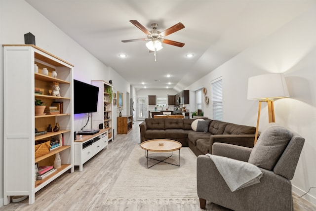 living room featuring ceiling fan and light hardwood / wood-style flooring