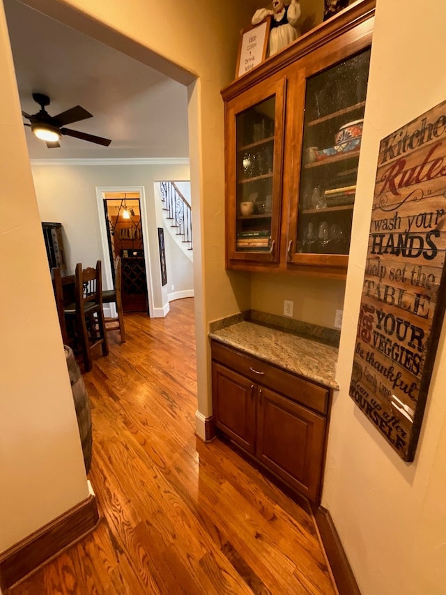 hallway featuring hardwood / wood-style flooring and ornamental molding