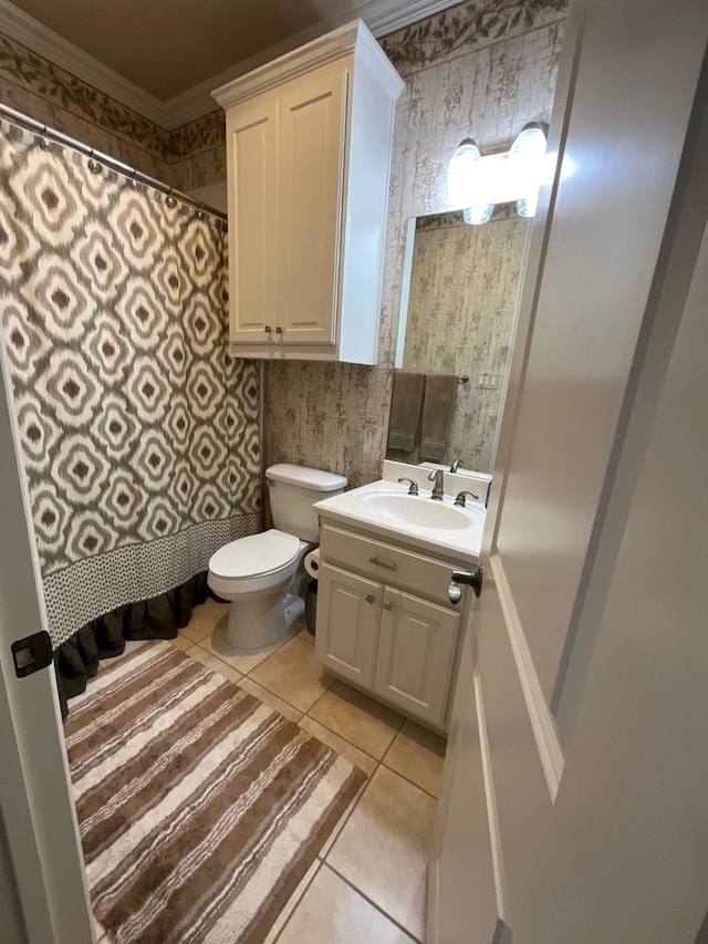 bathroom featuring tile patterned floors, crown molding, vanity, and toilet