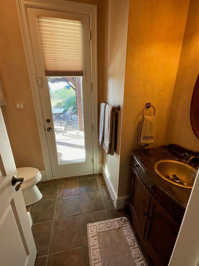 entryway with dark tile patterned flooring and sink