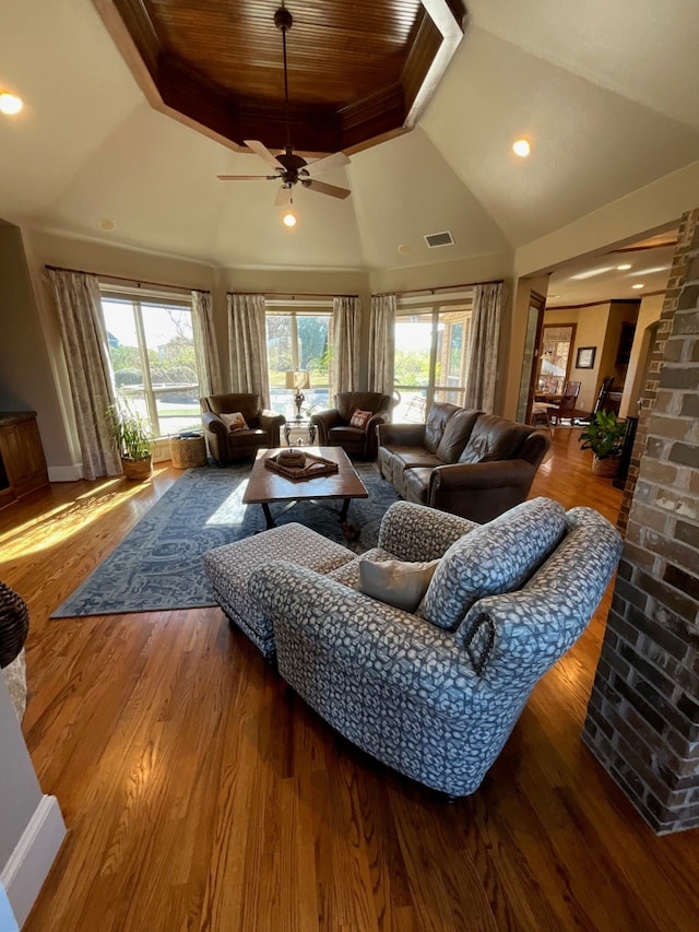 living room featuring hardwood / wood-style flooring, ceiling fan, and lofted ceiling