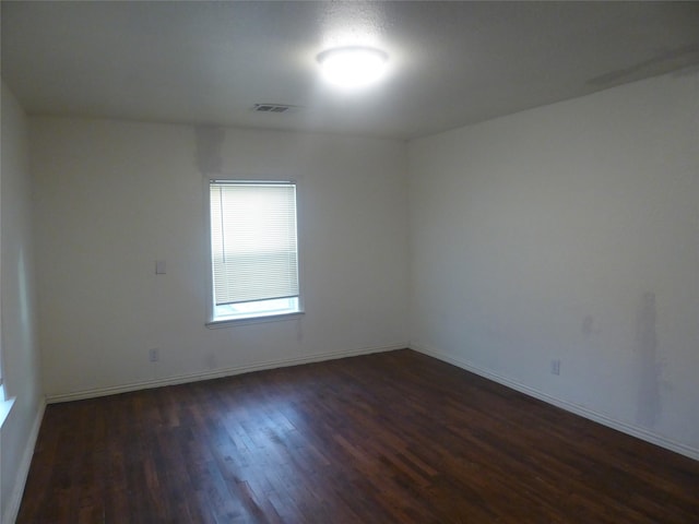 spare room featuring dark wood-type flooring