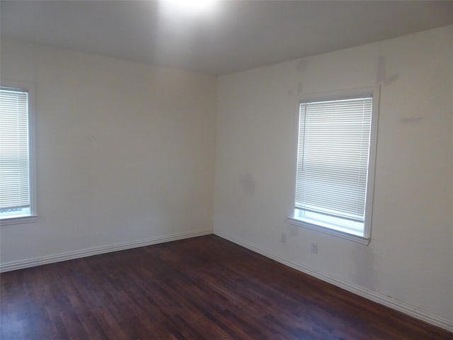 spare room featuring dark hardwood / wood-style flooring