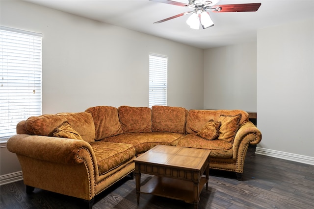 living room featuring ceiling fan and dark hardwood / wood-style floors