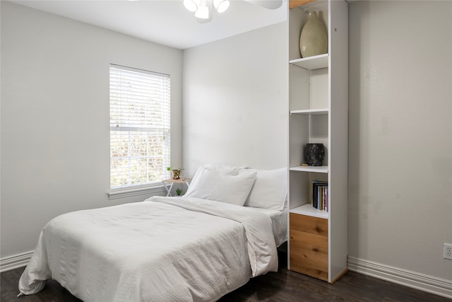 bedroom with multiple windows, ceiling fan, and dark wood-type flooring