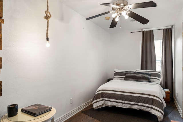 bedroom with ceiling fan and dark hardwood / wood-style flooring