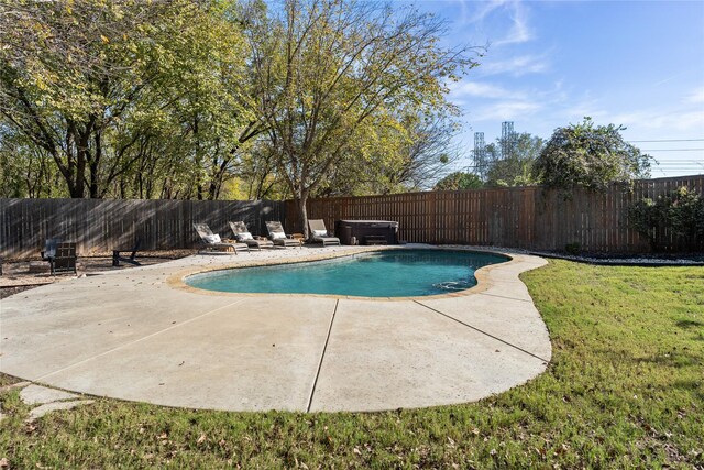 view of swimming pool featuring a lawn and a patio area