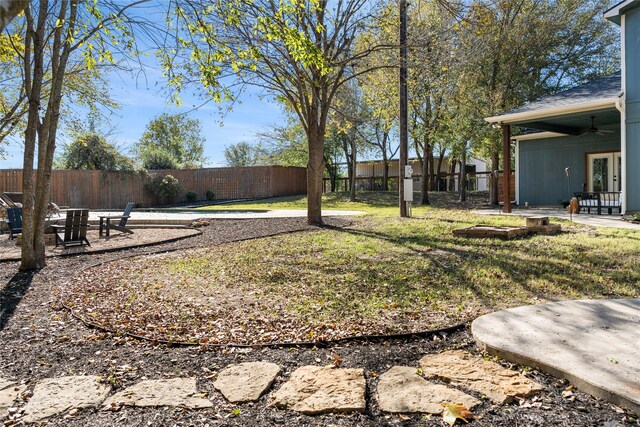 view of yard featuring ceiling fan and a patio area