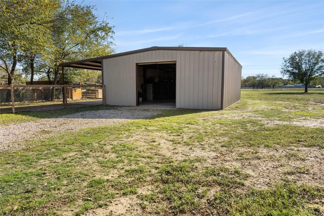 view of outbuilding with a yard