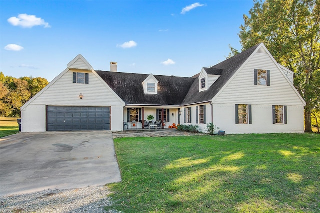 view of front facade featuring covered porch, a front yard, and a garage