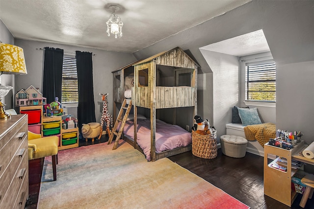 bedroom featuring dark hardwood / wood-style floors and a textured ceiling