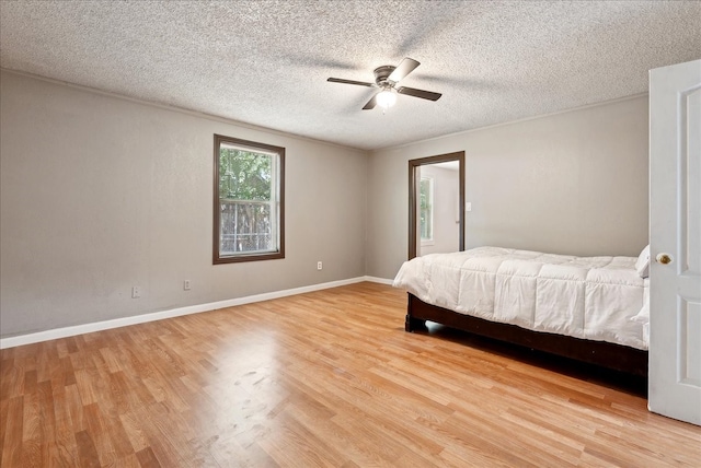 unfurnished bedroom with a textured ceiling, light hardwood / wood-style floors, and ceiling fan