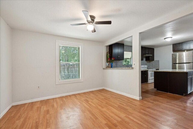 empty room featuring hardwood / wood-style flooring and ceiling fan