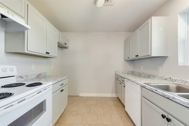 kitchen featuring sink, white cabinets, light stone counters, white appliances, and light tile patterned floors