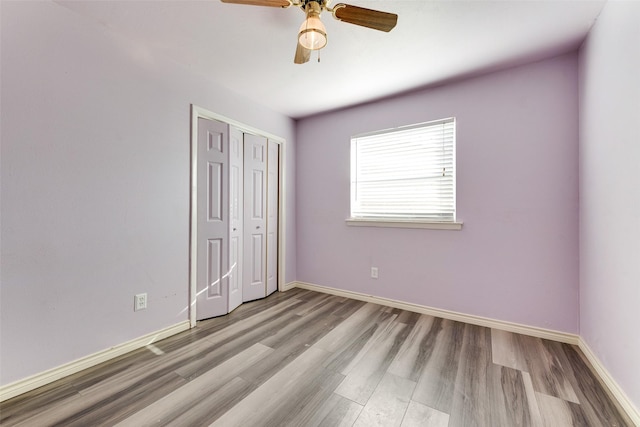 7421 Christopher Ct, North Richland Hills, TX 76180 - unfurnished bedroom featuring wood finished floors, a closet, and a ceiling fan
