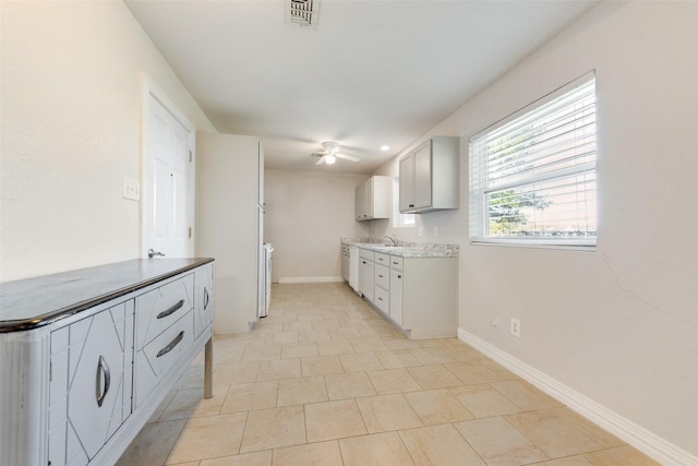 7421 Christopher Ct, North Richland Hills, TX 76180 - kitchen with ceiling fan, washer / clothes dryer, light tile patterned flooring, and light countertops
