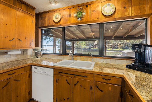 kitchen featuring wooden ceiling, white dishwasher, sink, vaulted ceiling with beams, and tasteful backsplash