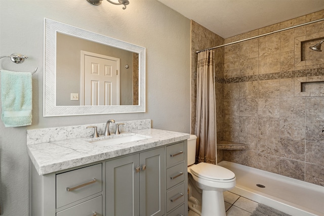 bathroom featuring a shower with curtain, tile patterned flooring, vanity, and toilet