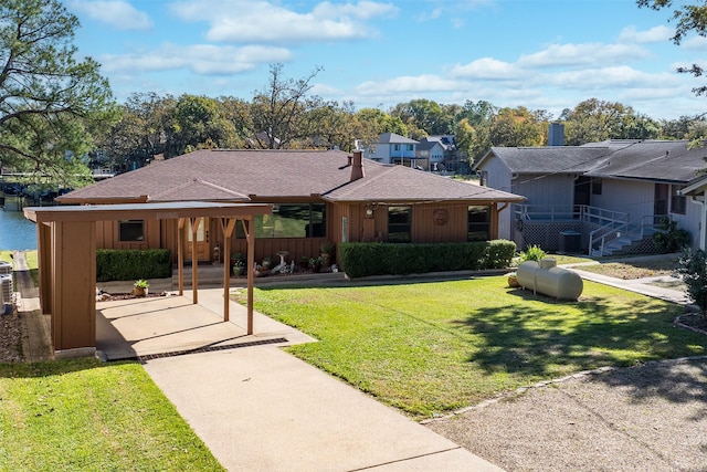 single story home with cooling unit and a front lawn