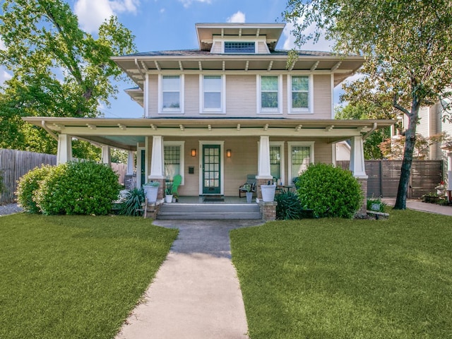 view of front of house featuring covered porch and a front yard