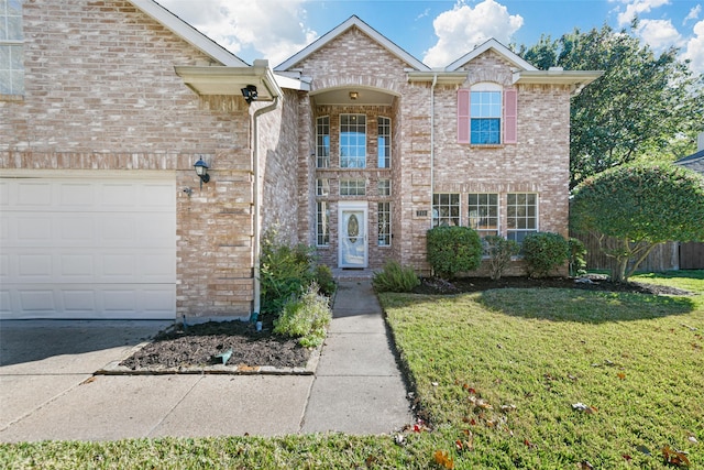 front facade with a garage and a front lawn