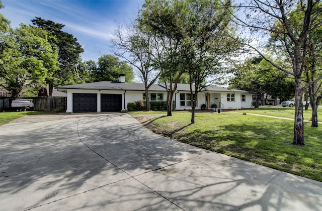 ranch-style home with a front yard and a garage