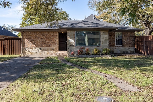 ranch-style house with a front lawn