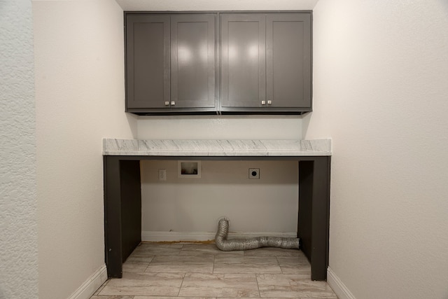 laundry room featuring cabinets, hookup for a washing machine, and electric dryer hookup