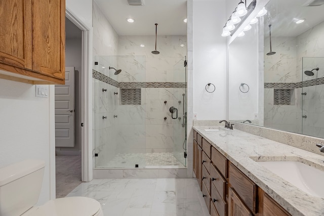 bathroom with vanity, toilet, and an enclosed shower