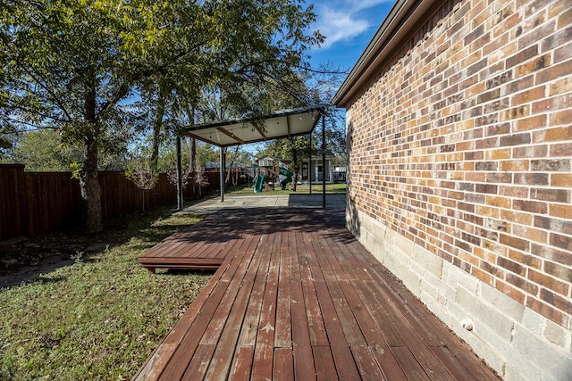 wooden terrace with a playground