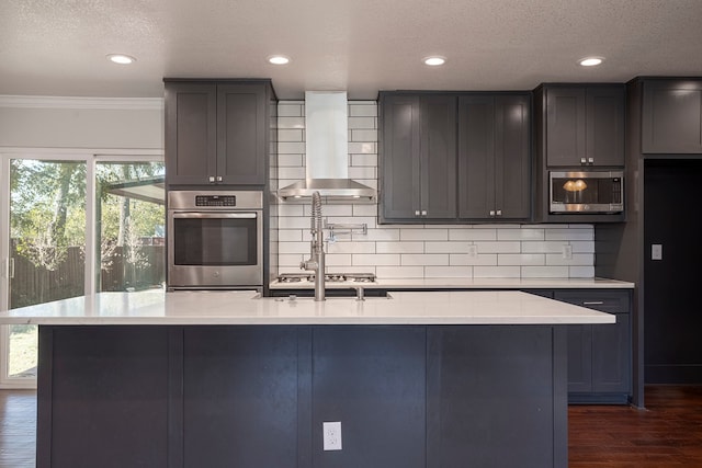 kitchen with backsplash, ornamental molding, stainless steel appliances, dark wood-type flooring, and wall chimney range hood