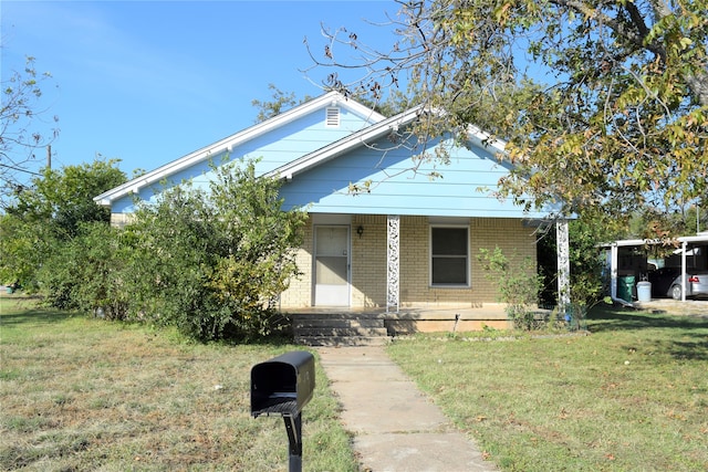 view of front of home with a front lawn and covered porch