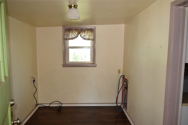 laundry area with dark hardwood / wood-style floors