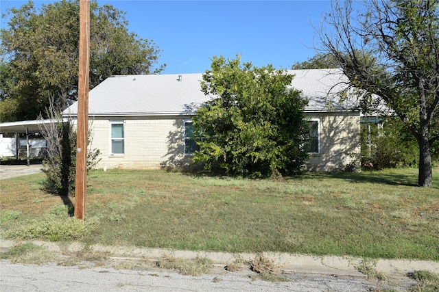 view of home's exterior featuring a carport and a yard