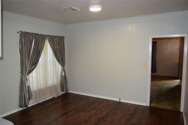 unfurnished room featuring dark wood-type flooring