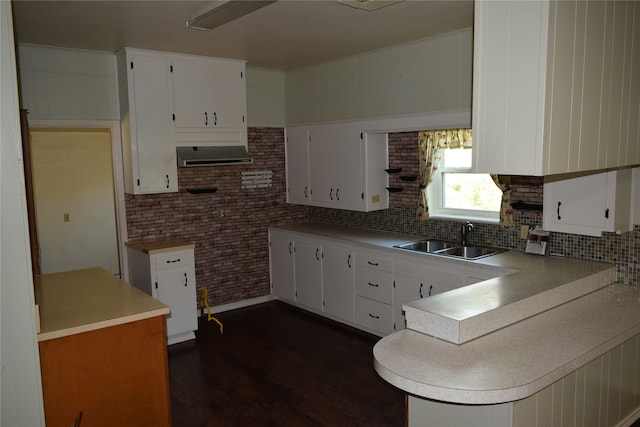 kitchen featuring dark hardwood / wood-style flooring, white cabinetry, and sink