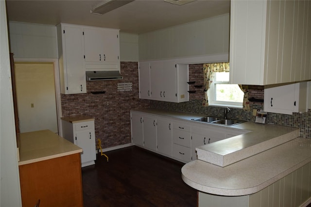 kitchen featuring dark hardwood / wood-style flooring, sink, decorative backsplash, and white cabinets