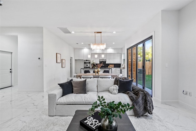 living room with sink and a notable chandelier