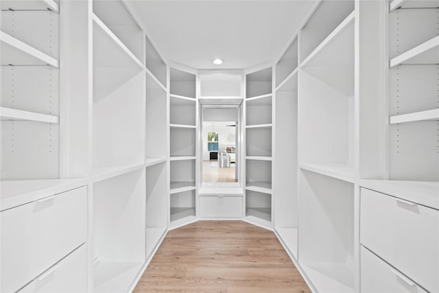 spacious closet with light hardwood / wood-style floors